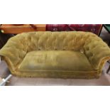 A three seater chesterfield settee with deep button back upholstered in gold length 190 cm on turned