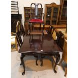 A mahogany reproduction dining suite comprising shaped rectangular table and 6 (4 + 2) chairs on