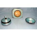 A 1930's blue enamel dressing table clock, trinket jar and pin tray (import marks)