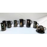 A collection of 9 pieces of Victorian pottery in Jackfield style black glaze - jugs, etc.
