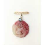 A Chinese carved hardstone pendant in pink and white on yellow metal bar brooch, stamped '9 ct'