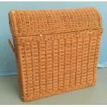 A woven cane linen basket with dome top