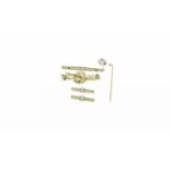 A 9 carat hallmarked 2 tone gold bar brooch with horseshoe, a filigree bar brooch, stamped '10K' (