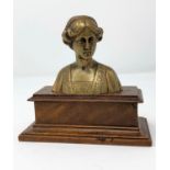 A brass bust of Beatrice on wooden plinth, height 12 cm