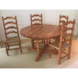 A modern pine dining suite comprising circular table and 4 ladder back rush seat chairs