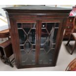 A 19th century mahogany straight front corner cupboard enclosed by 2 glazed doors