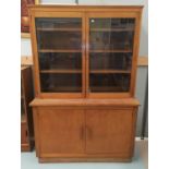 A 1930's stained oak full height bookcase with 2 glazed and 2 panelled doors