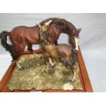 A modern resin sculpture: horse and foal, monogrammed 'GA', on wooden plinth
