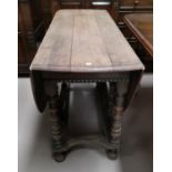 A Late 19th/early 20th oak drop leaf dining table with turned legs