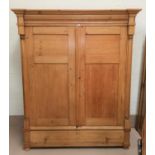 A 19th century stripped pine double door wardrobe with turned side columns and base drawer, width