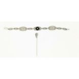 An Art Deco white metal filigree oval link bracelet stamped '14K' set with 3 small diamonds, 8gm,