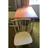 An orange drop leaf kitchen table and 2 chairs; a light oak writing table