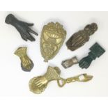 A Victorian cast iron hand as paperweight; similar door knocker; a white metal fist shaped vesta