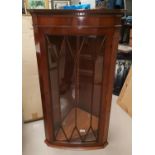 A reproduction yew wood wall hanging corner cupboard