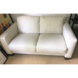 A modern cream leather 3 piece suite comprising 2 seater settee and pair of armchairs