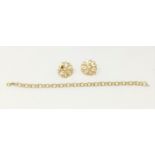 A yellow metal triple link bracelet, stamped '14K'; a pair of flower head earrings, stamped '14K';