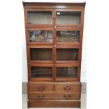 An early 20th century inlaid oak sectional bookcase, 4 height, with 2 short and 1 long drawers