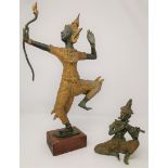 A bronze and gilt oriental figure of a man with bow and a similar smaller figure of seated person