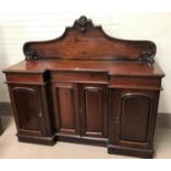 A Victorian mahogany 4 door sideboard with reverse breakfront, carved raised back, 3 frieze