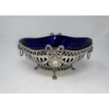 A Georgian style white metal bowl stamped 925 with blue liner, flower and swag decoration with embo