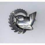 Georg Jensen, a Danish silver brooch, a wren sitting on a fern branch, stamped GEORG JENSEN in