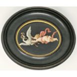 A 19th century oval ceramic plaque enamelled with putto grasping a swan, 13 x 16 cm, framed