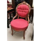 A Victorian walnut nursing chair in buttoned burgundy