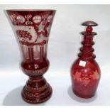 A 19th century Bohemian ruby overlaid and cut back vase, height 17cm; a similar decanter