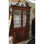 A Regency style inlaid mahogany full height display cabinet by Dickinson's of Ipswich, with 2