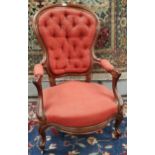 A Victorian mahogany framed spoon back armchair with knurled arms and legs, deeply buttoned in