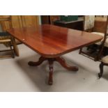 A Victorian mahogany dining/side table with small detachable side leaf on four foot pedestal base