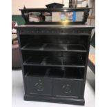 An Aesthetic movement ebonised side cabinet with raised mirror back, 3 open shelves and double