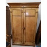 An Arts & Crafts ash wardrobe with banded ebony inlay, double doors and part fitted interior, on