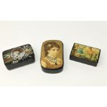 A late 19th century lacquer snuff box with chromolitho genre scene to the lid, 9 cm; 2 others