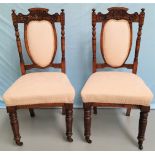 An Edwardian set of 6 carved and stained wood dining chairs, the seats and backs in cream fabric
