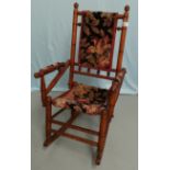 A child's stained wood American rocking chair