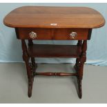 A Victorian mahogany occasional table with rounded rectangular top, frieze drawer and 2 shelves