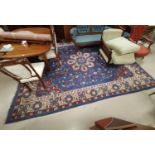 An early 20th century Indian carpet square with Persian design on blue ground