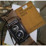 A Rolleicord TLR camera in leather case, with handbook