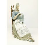 A Lladro figure of woman sewing in high back chair