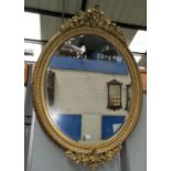 A 19th century oval ornate gilt framed wall mirror
