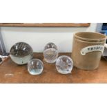 A small selection of large clear glass paperweights and Victorian green glass dumpies