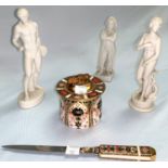 Three white bisque figures; a Royal Crown Derby Imari pattern table lighter (hairline crack to base)