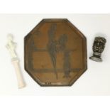 A cast and bronzed metal printing plate depicting a stylish 1920's woman, 18 cm high; a seal with