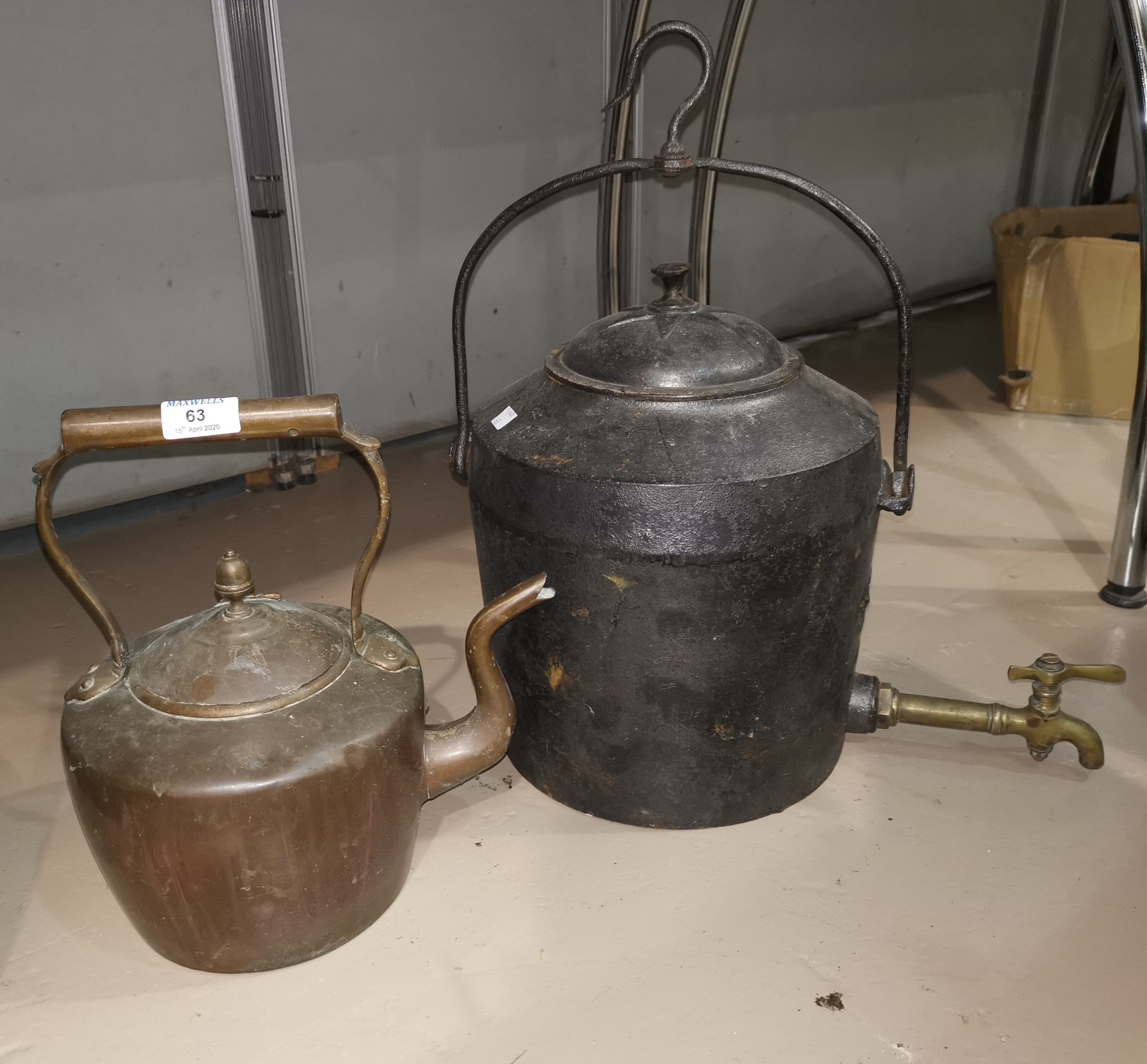 A 19th century copper kettle; a large 19th century cast iron kettle;