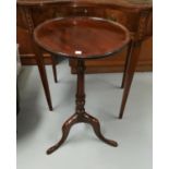 A mahogany pedestal wine table