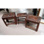 A nest of 3 oriental carved hardwood occasional tables