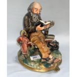 A Capodimonte group: seated man reading a book