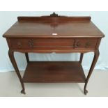 An Edwardian mahogany side table with frieze drawer and undershelf, on cabriole legs