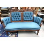 A late Victorian 2 seater settee with carved walnut kidney shaped frame on turned legs, deeply